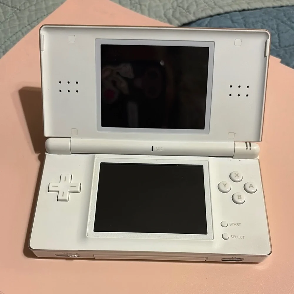 White Handheld Gaming Console with Pink Ribbon